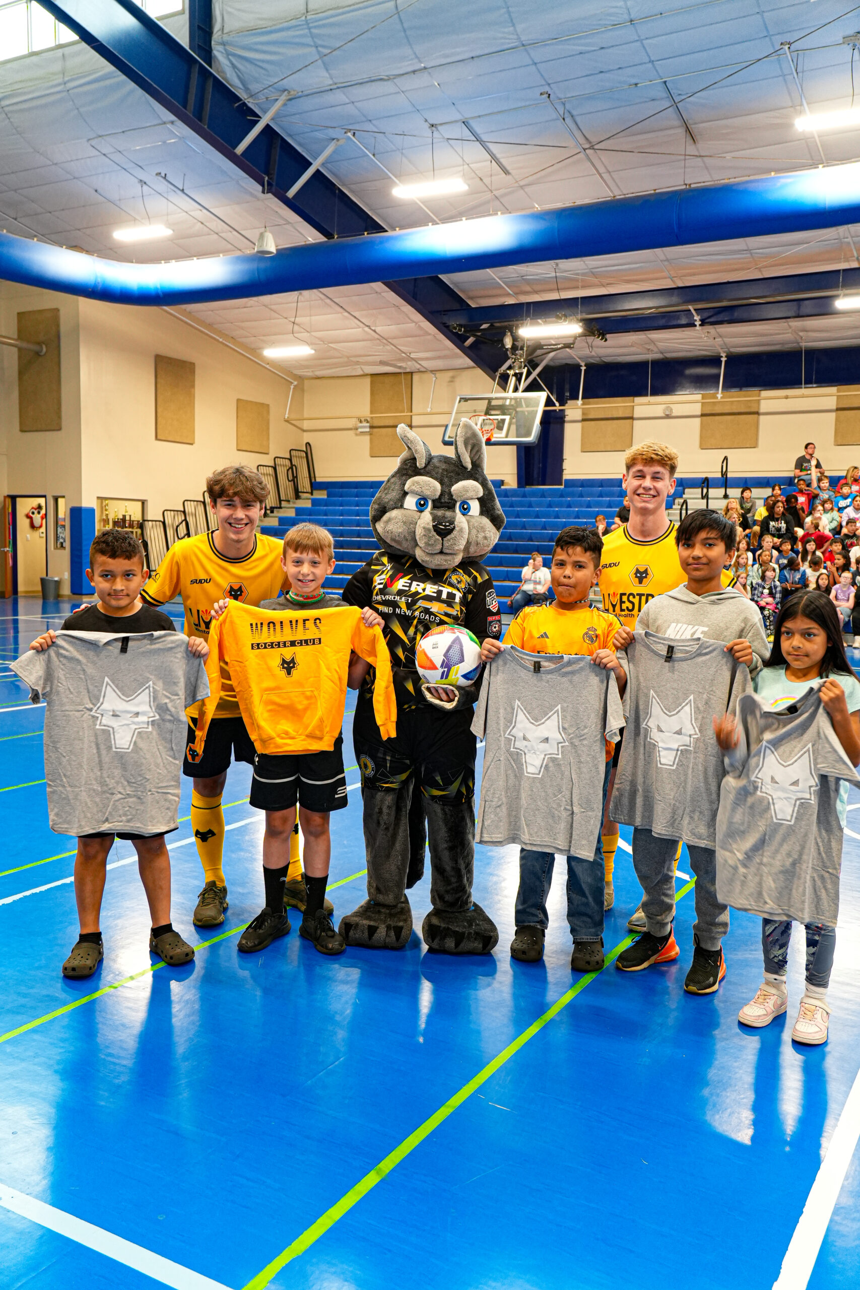 Arkansas Wolves players and young people at a community event